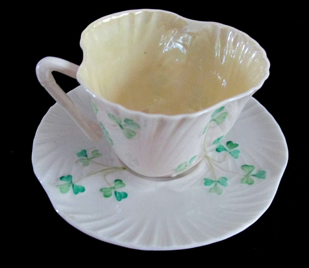 Irish Belleek Shamrock Shaped Cut & Saucer: Probably 1960s or 70s era, green marking of Irish Belleek, paper thin with luster interior to the cup. Normal small teacup and saucer size.