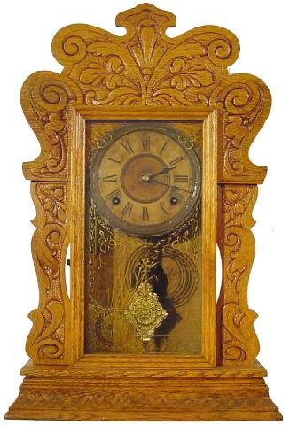 Sessions 1900 Era Kitchen Clock: About 100 Years Old, This Refinished Oak Sessions Clock Has An Ornate Brass Pendulum, Scroll & Leaf Crest, Lattice Work Base, 22 1/2 Tall by 14 1/2 Wide, Gold Toned Stencil On Door w/Flowers In Urn In