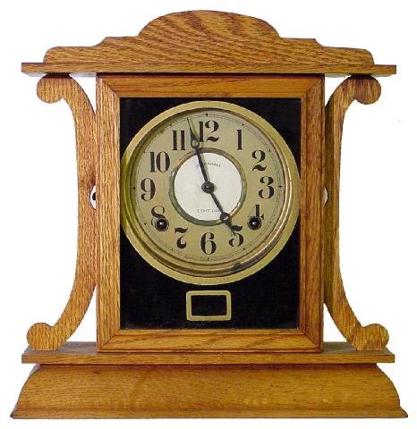 Ingraham Oak Mission Style Kitchen Clock: The Face Is Mostly Original Except For The Center Replacement Stating Ingraham 8 Day, The Refinished Case w/Black Reverse Painted Face Cover Is Trimmed In Gold, 13 1/2 Tall by 13 Wide, Clean Lines & E