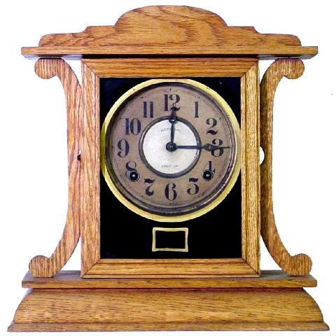 Ingraham Oak Mission Style Kitchen Clock: The Face Is Mostly Original Stating Ingraham 8 Day, The Refinished Case w/Black Reverse Painted Face Cover Is Trimmed In Gold, 13 1/2 Tall by 13 Wide, Clean Lines & Easily Useable With Any Room Style