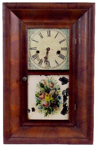 Waterbury Ogee Small Mantel Time Piece, 19th Cent: Painted Tin Face w/Very Minor Flaking, Blue Designs At Each Corner Of Face, Floral Bouquet Print Glued To Front Tablet w/Some Wear & Spots, There Are Very Minor Nicks To Veneer Along Top Left Corner,