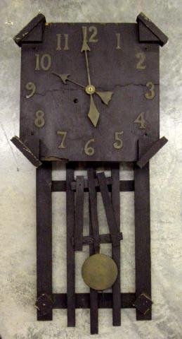 Oak Mission Style Wall Clock: Dark Oak Finish, Brass Numbers, Architectural Angled Corners, Line Cracked Going East To West In Center Of Face Also w/Veneer Chip Lower Left Corner, Mission Style Back Decoration Behind Pendulum, 30