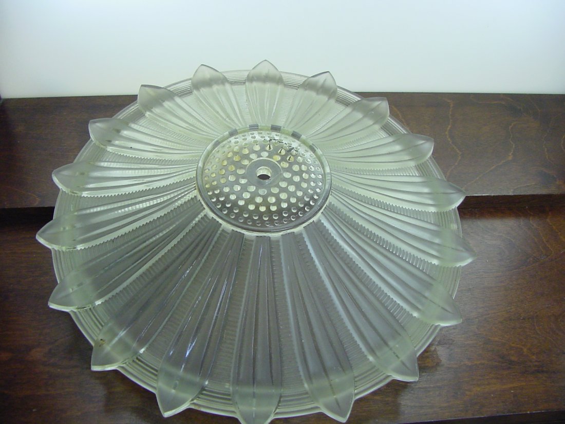 Ceiling Petal Shade: Ceiling fixture, 14" by 3 1/2" tall, clear glass, with a sort of petaled design, 1 nick on the top of the teeth, center attachment.