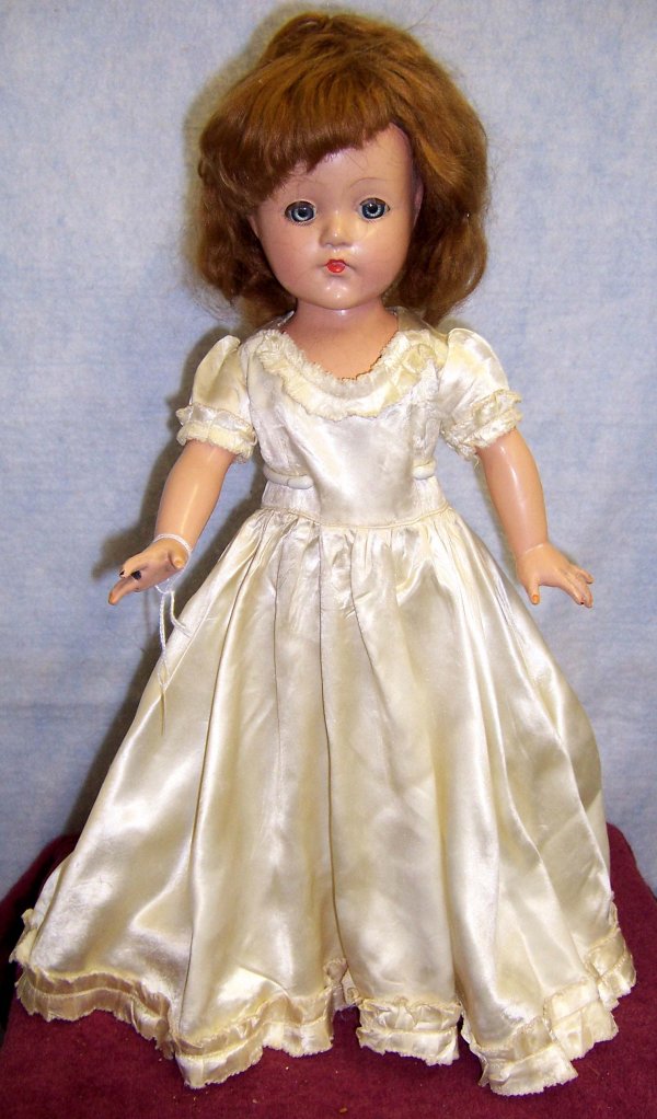 EFFANBEE Honey doll: 18 in. tall appears to be in original clothing. Wig in fair condition, Blue sleep eyes, left eye lash missing a couple of hairs, bottom lashes are painted. Closed mouth. Doll is hard plastic, skin pai