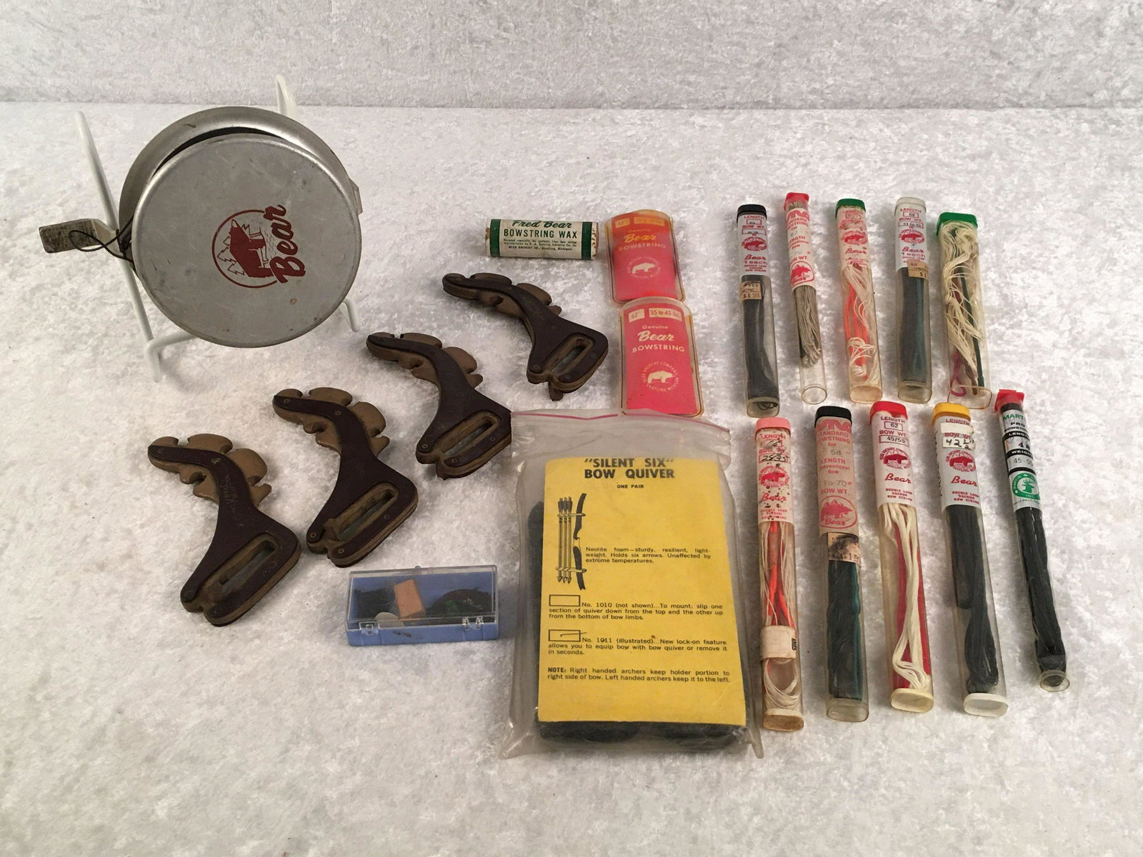 Group of Archery Accessories. Bear Archery Bowstrings,: Group of Archery Accessories. Bear Archery Bowstrings, Various Lengths and Weight. Bear Rest, Fred Bear Bowstring Wax, Bear Bow Fishing Spool, Kwikee Kwivers, Silent Six Bow Quiver.
