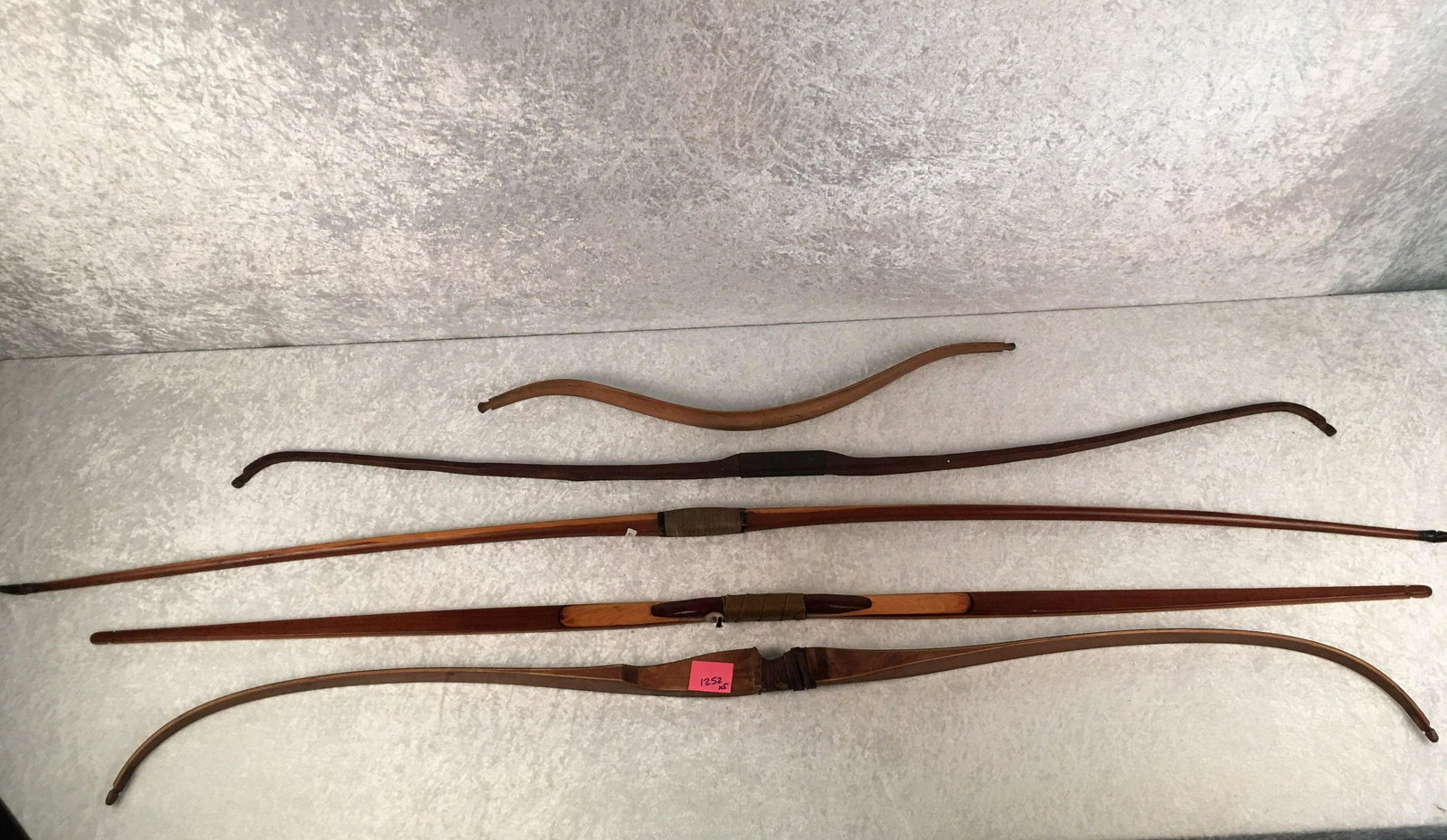 (5) Vintage Bows. York Archery Supercrest. 62"; Asian: (5) Vintage Bows. York Archery Supercrest. 62"; Asian Horse Bow 29"; Unmarked 72" Cedar Long Bow with Horn Tips; Unmarked 64" Laminated Long Bow; Unmarked Two Piece Take Down Long Bow 58"