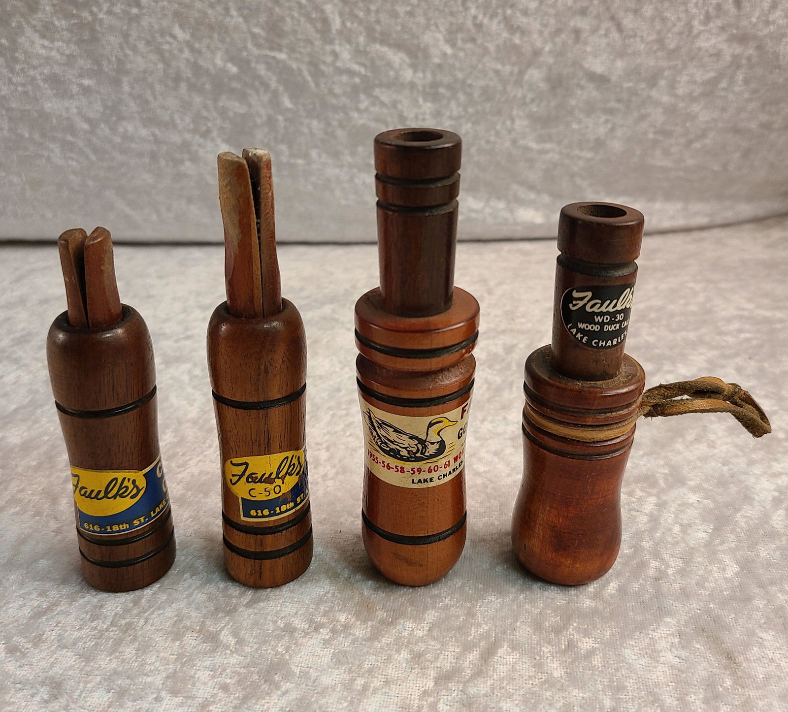 Lot of (4) Faulk's Calls: Lot of (4) Faulk's Calls: C-50 Crow Call, CH-44 Goose Call 1955-56-58-59-60-61 World Champions, Crow Call, & WD-30 Duck Call