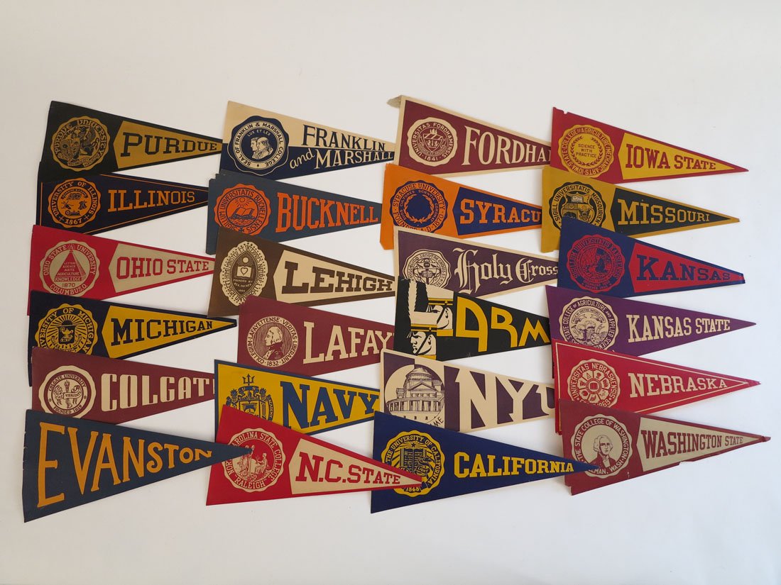 (24) College Paper Decal Pennants 8" Unused: Lot of 24 Paper Decal College Pennants. Unused Adhesive on Back. Approx. 8"