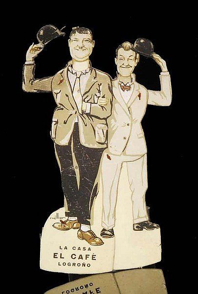 LAUREL AND HARDY MOVING ADVERTISING BOARD.: Laurel & Hardy - A 1930s printed cardboard advertising panel for La Casa El Cafe - Logrono with movable parts depicting Stan Laurel and Oliver Hardy raising bowler hats in turn