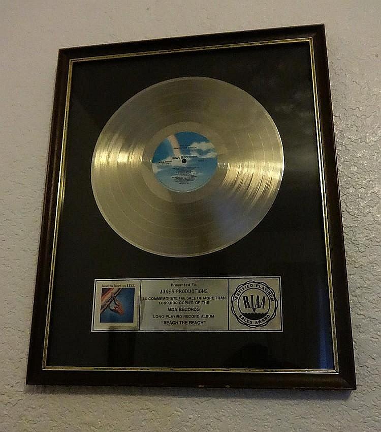 THE FIXX REACH THE BEACH RIAA AWARD.: RIAA AWARD: The Fixx for Reach the beach. A platinum award to commemorate the sale of over 1,000,000 copies, presented to Jukes productions.