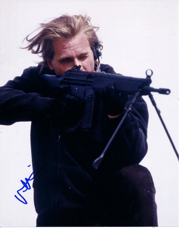 Val Kilmer Autographed Photograph: VAL KILMER (American Actor) Autographed publicity photograph. Signed by Val Kilmer in blue felt tip pen. Includes COA. Dimensions: 8 inches by 10 inches