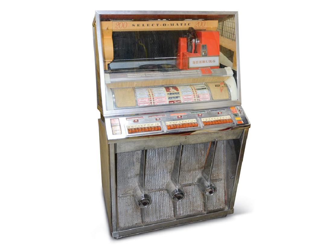 Seeburg Model No. KD-200 Coin-Op Jukebox: Seeburg Model No. KD-200 Coin-Op Jukebox Condition: Original 57 × 35 × 26 in. This is in good condition. When turned on the machine lights up but it is inoperable. It is full of 45s and looks comple