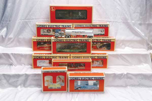 Lionel Motorized Units/Club/Freight Cars 18424 LL: 18424 LL on-track pick-up truck, 18425 Goofy and Pluto hand car, 12854 US Navy tractor-tanker, 16429 WM hopper 2-pack, 16686 Mickey and Bad Pete animated boxcar, 16720 LL extension searchlight car, 16