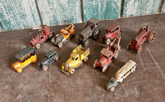 Cast Iron Toys: Includes two tractors, two tow trucks, one bus, one firetruck, one dump truck and two sedans.