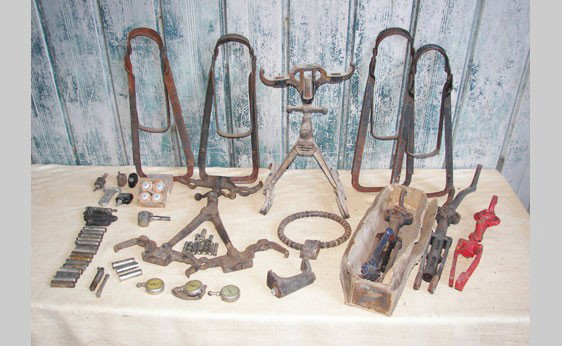 Miscellaneous Auto Parts: Two Duplex spare tire carriers, a group of spare tire locks including a cast iron model with Chevrolet script, rim spreader tools and an assortment of Schreider tire pressure gauges including one from