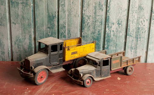 Pressed Steel Trucks: Two Buddy-L trucks, one is an ice delivery truck with closed cab and opening doors, headlamps, and bumpers, the other is a Buddy-L junior express truck.