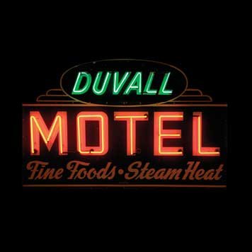 2098-Duvall Motel Neon: Features appealing die-cut shape and Art Deco styling.Colors, finish are bright and glossy. Surface is largely free of flaws, showing only minor scratching. Minor chipping is evident around perimeter.