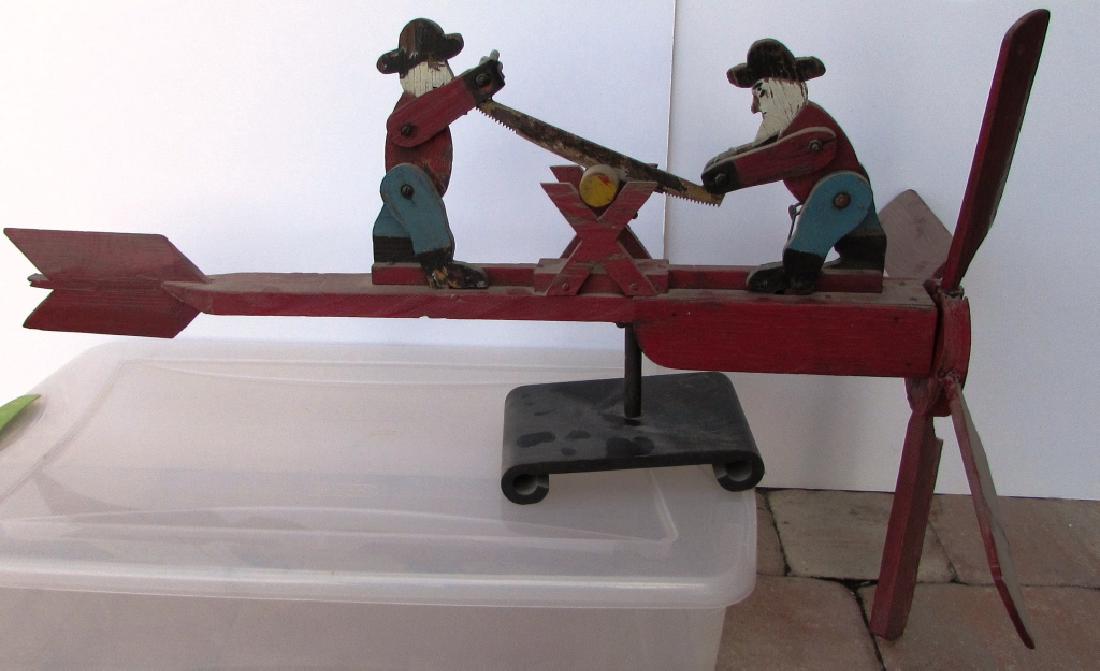 ANTIQUE WOOD WHIRLIGIG WEATHERVAYNE CROSSCUT PLANE: WOOD WHIRLEYGIG WEATHERVAYNE - TWO MEN SAWING LOG / PROPELLER ON BASE. 32" LONG x 13" TALL.
