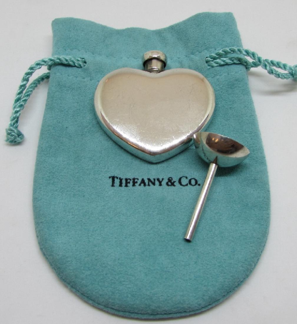 TIFFANY & CO STERLING SILVER PERFUME FLASK FUNNEL: TIFFANY & CO. STERLING SILVER HEART PERFUME BOTTLE WITH MATCHING STERLING FUNNEL. BOTTLE IS 1.5" TALL, FLASK 1.25" TALL. 21.7 GRAMS. TIFFANY CLOTH BAG INCLUDED. (USA SHIPPING $10)