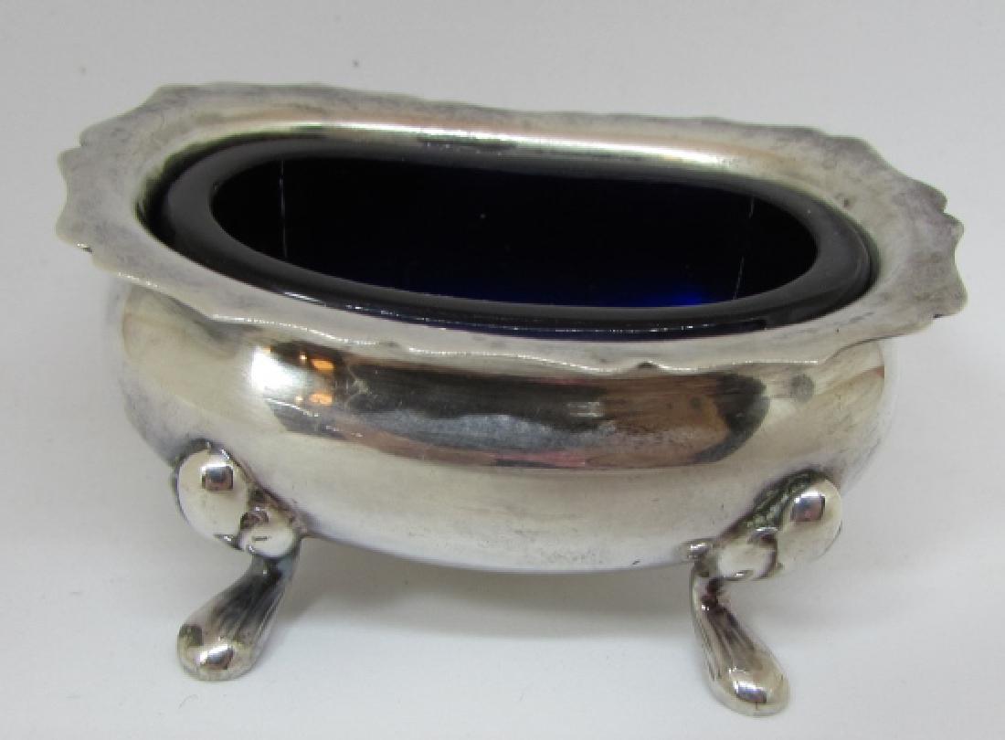 TIFFANY & CO BOWL STERLING SILVER COBALT VANITY: AUTHENTIC FOOTED SALT CELLAR DISH, COULD USE TO HOLD RINGS OR EARRINGS. MEASURES 2 1/4" x 1 5/8". WEIGHS WEIGHS 33.5 GRAMS WITHOUT GLASS. EXCELLENT CONDITION ANTIQUE, 2 SMALL DINGS. (USA SHIPPING $12)