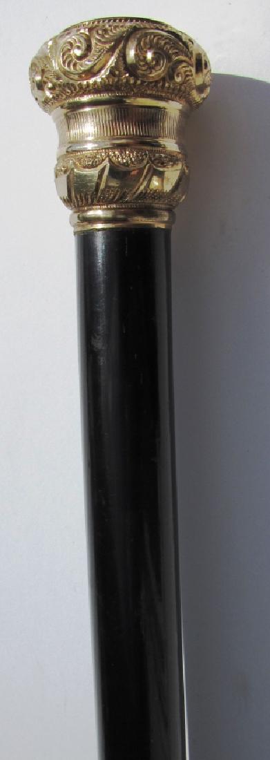 GOLD TOP PRESENTATION CANE EBONY WOOD 1 3/8" WIDE: GOLD TOP PRESENTATION WALKING STICK. 34 5/8" TALL, TOP IS 1 3/8" WIDE, 1 1/2" TALL.