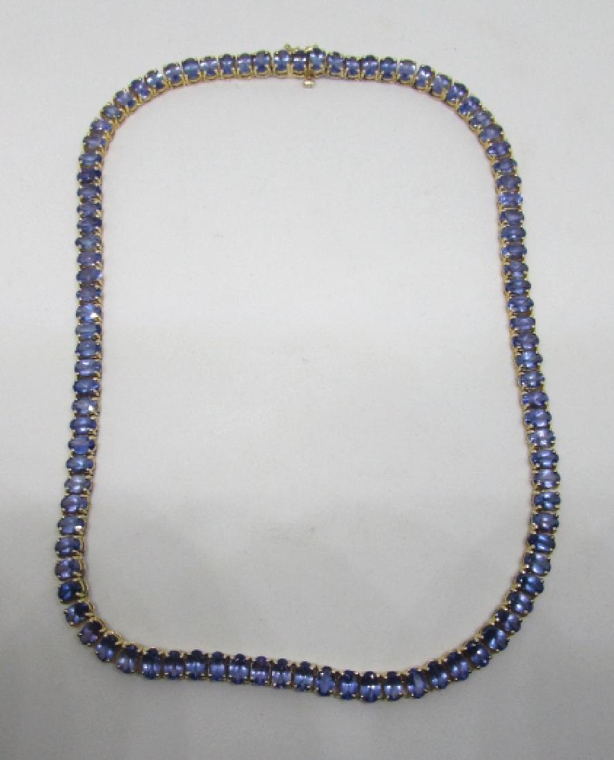 34 CARAT TANZANITE NECKLACE 14K YELLOW GOLD 17": 97 PURPLE BLUE .35CT GENUINE TANZANITE GEMSTONES. WEIGHS 30 GRAMS OF 14K YELLOW GOLD. 17 INCHES LONG BY 6MM WIDE. EXCELLENT CONDITION ESTATE SHOW STOPPER.