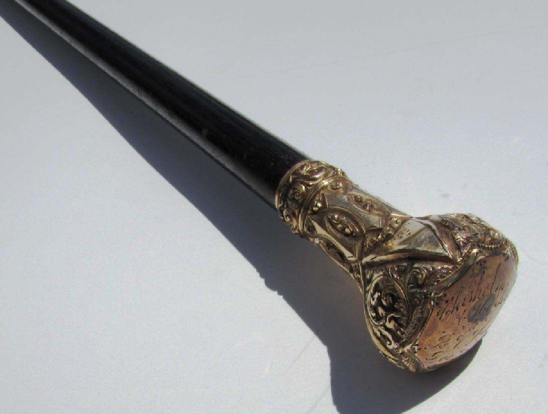 EBONY GOLD PRESENTATION CANE 1889: ANTIQUE EBONY WOOD CANE . 35 1/4" LONG, 1 5/16" HANDLE. ENGRAVED (CHISHOLM & HOPKINS TO R.V HURD DEC 25 89) (25M)