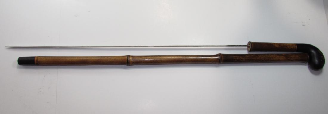 WOOD SWORD CANE TOLEDO IRONWOOD BAMBOO GOLD INLAY: GOLD INTARSIA VICTORIAN ERA SWORD CANE, MADE IN TOLEDO SPAIN. 23 3/4" BLADE, 31 1/4" LONG WHEN DRAWN, 35 5/8" IN SHEATH. BLADE IS WELL HIDDEN, HOLDS TIGHT IN SHEATH; VERY LITTLE PLAY.