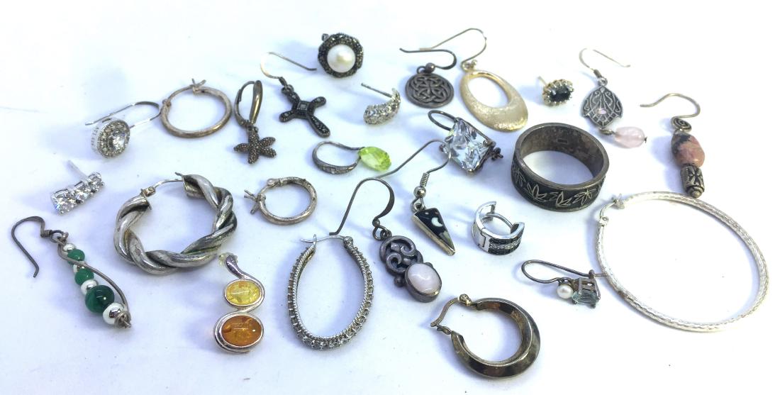 48 GRAMS LOT OF STERLING EARRINGS JEWELRY: VARIOUS SIZES STONES AND SHAPES. MARCASITE, MALACHITE, CZ AND MORE. ALL PIECES ARE MARKED STERLING AND TESTED. ALL PIECES ARE NON MATCHING EARRINGS AND ONE RING, GOOD LOT TO JEWELRYSMITH INTO PENDANTS