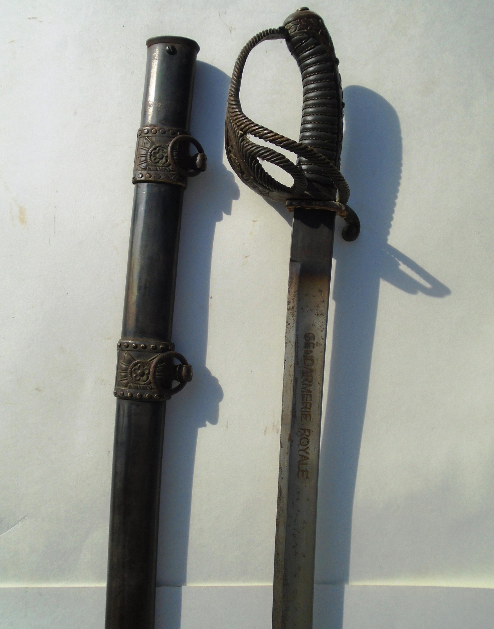 GENDARMERIE ROYALE SWORD WWII SINO-JAPANESE WAR: SECOND SINO-JAPANESE WAR SWORD & SCABBARD. ENGRAVED "GENDARMERIE ROYALE". 29.5" BLADE, 35" OVERALL. (US SHIPPING $25)