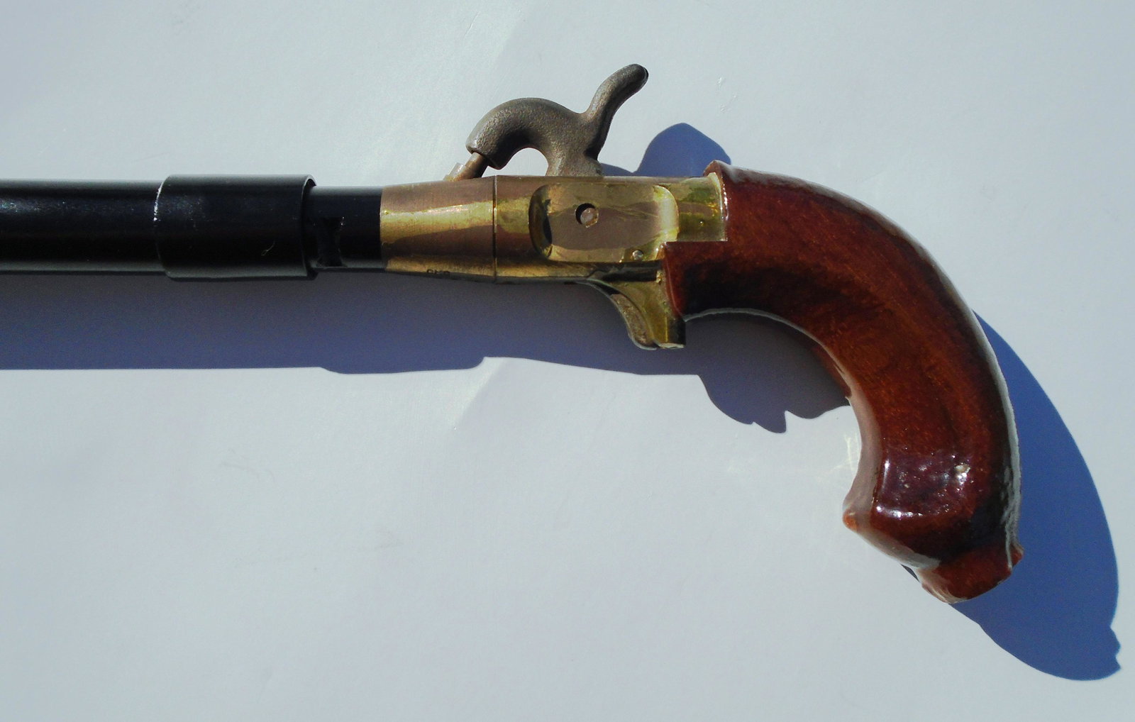 GUN CANE CMC BLACK POWDER PERCUSSION CAP PISTOL: CMC PISTOL HANDLED GUN CANE. 5" WIDE, 37 3/8" TALL. HAMMER & TRIGGER FUNCTIONAL. SERIAL #99560A US SHIPPING 25