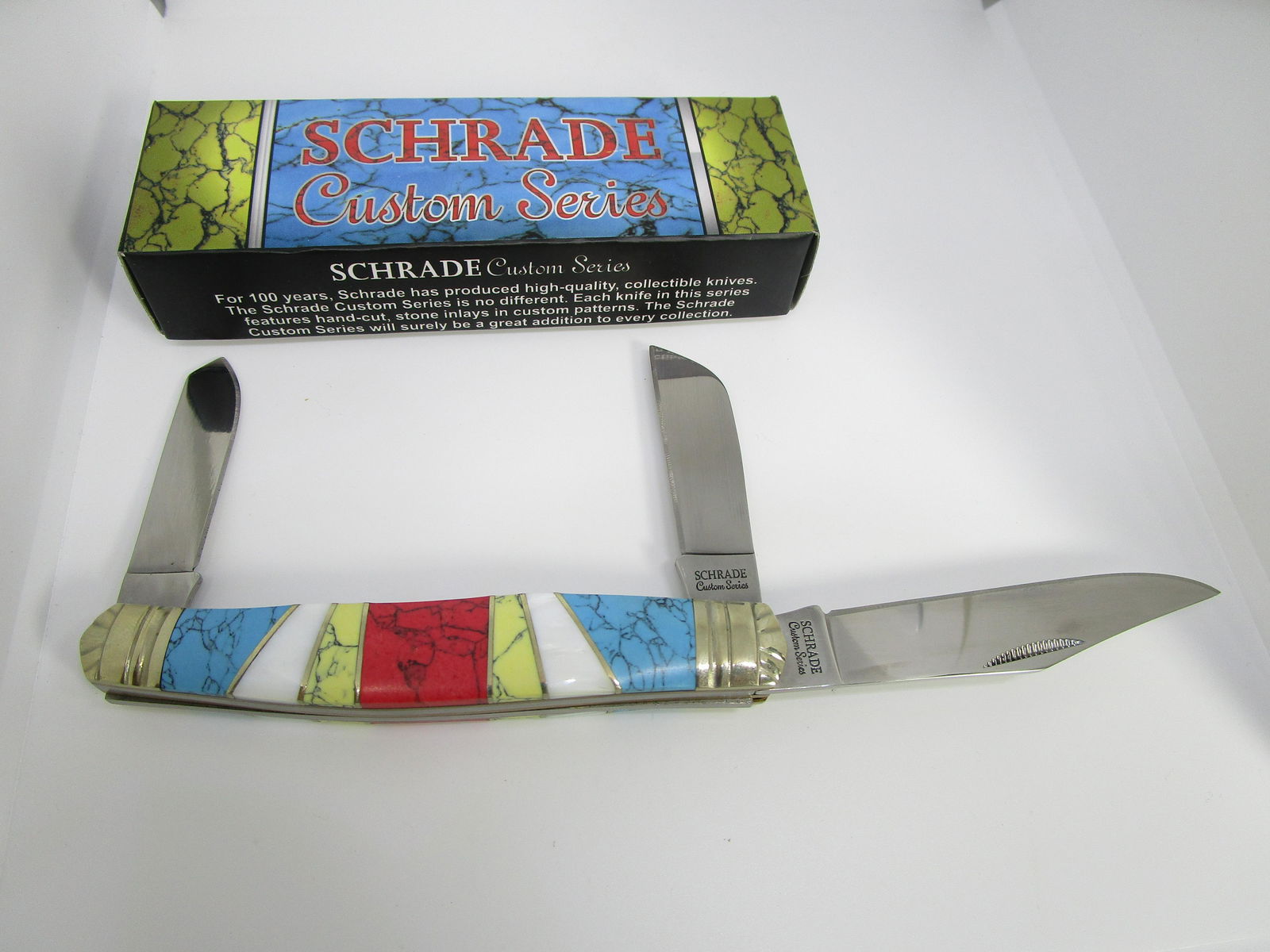 SCHRADE CUSTOM SERIES TURQUOISE POCKET KNIFE: 3 BLADE POCKETKNIFE WITH INLAID ABALONE, COMPOSITE/BLOCK TURQUOISE, RED & YELLOW STONE. MEASURES 4-1/4" CLOSED, LONGEST BLADE IS 3". BOX SHOWS WEAR. (USA SHIPPING $5)