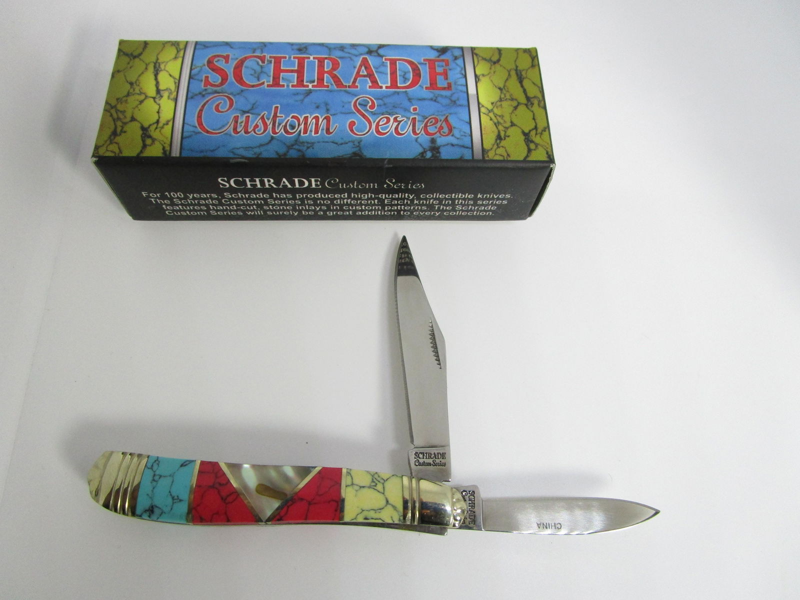 SCHRADE CUSTOM SERIES TURQUOISE POCKET KNIFE: 2 BLADE POCKETKNIFE WITH INLAID ABALONE, COMPOSITE/BLOCK TURQUOISE, RED & YELLOW STONE. MEASURES 2-3/4" CLOSED, LONGEST BLADE IS 2". BOX HAS WRITING ON IT. (USA SHIPPING $5)