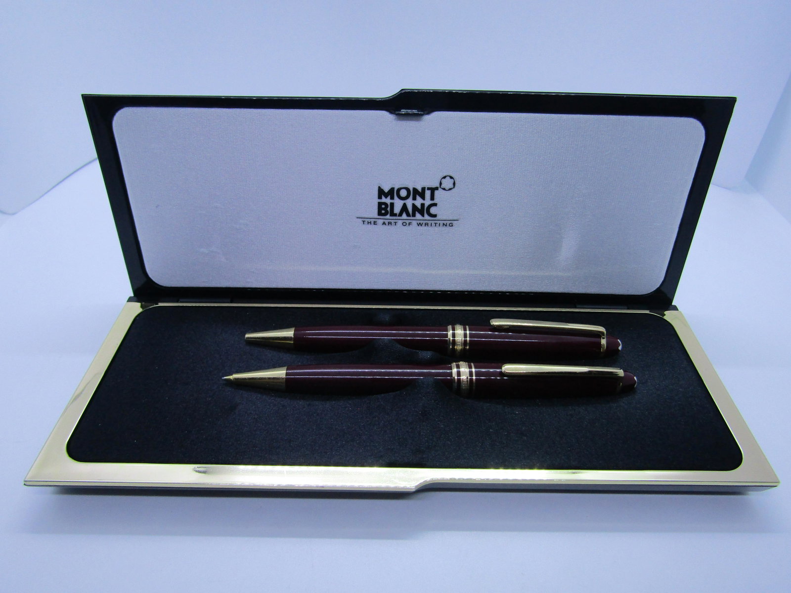 MONTBLANC MEISTERSTUCK BURGUNDY PEN PENCIL SET: BURGUNDY OR BORDEAUX RED PEN PENCIL SET IN GIFT BOX. PEN IS MARKED "W GERMANY" PENCIL IS MARKED "DD1978429 GERMANY" BOX IS 8.5" X 3.5", BOTH INSTRUMENTS ARE 5-3/8". THESE ARE IN GOOD VINTAGE CONDITION