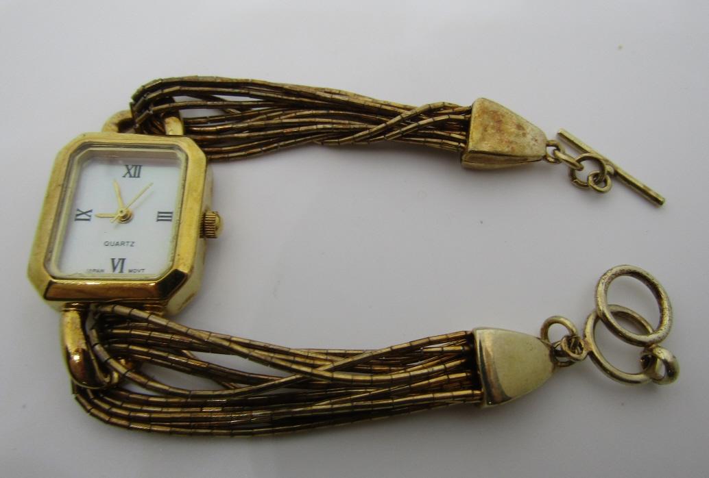 SHUBE DAKOTA GOLD STERLING SILVER WATCH BRACELET: MARKED "S" SHUBE DAKOTA WEST WATCH WITH MOP FACE AND GOLD ON LIQUID SILVER BRACELET BAND. MEASURES 7.5" LONG. WEIGHS 28.6 GRAMS TOTAL. USA SHIPPING $5.