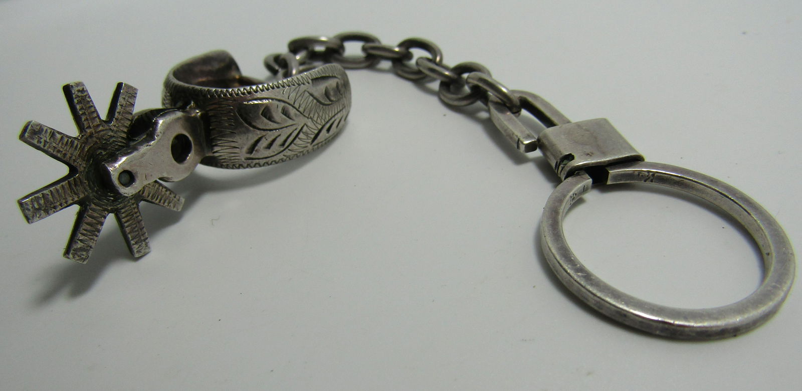 STERLING SILVER COWBOY BOOT SPUR KEYCHAIN: CHAIN MEASURES 6.25" LONG. MOVEABLE SPINNING SPUR IS 0.75" DIAMETER. VINTAGE. MARKED & TESTED 925 SILVER. WEIGHS 29.7 GRAMS. USA SHIPPING $5