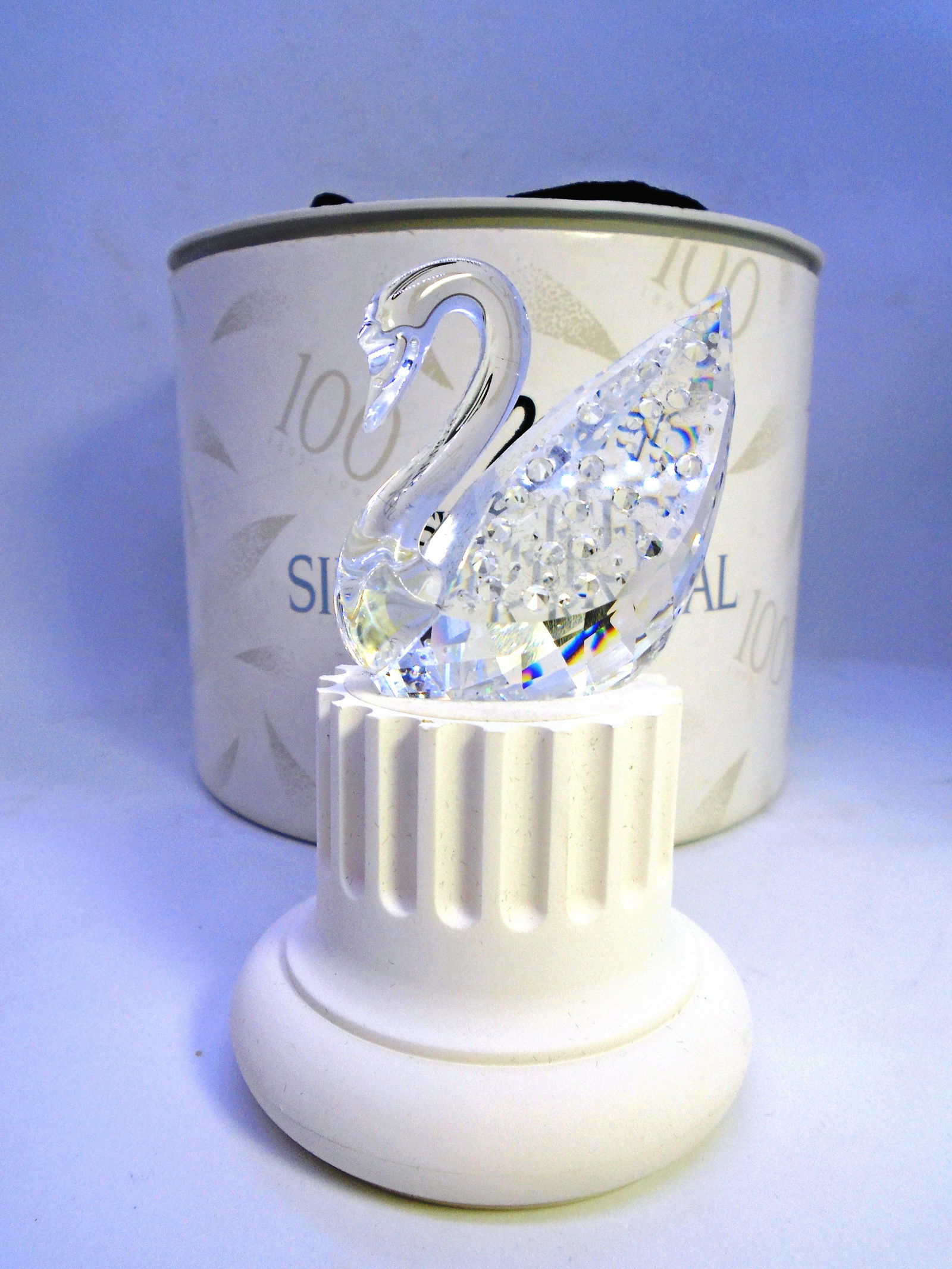 SWAROVSKI SILVER CRYSTAL SWAN STATUE 1995 BOX 7633: SWAROVSKI CRYSTAL CENTENNIAL SWAN 1895-1995. 100 YEARS WITH 100 CRYSTALS. RETIRED 7633NR10000. 0. 2" TALL, 2" LONG, 1 3/8" WIDE. NO CHIPS OR CRACKS. ORIGINAL BOX & STAND INCLUDED. (US SHIPPING $15)