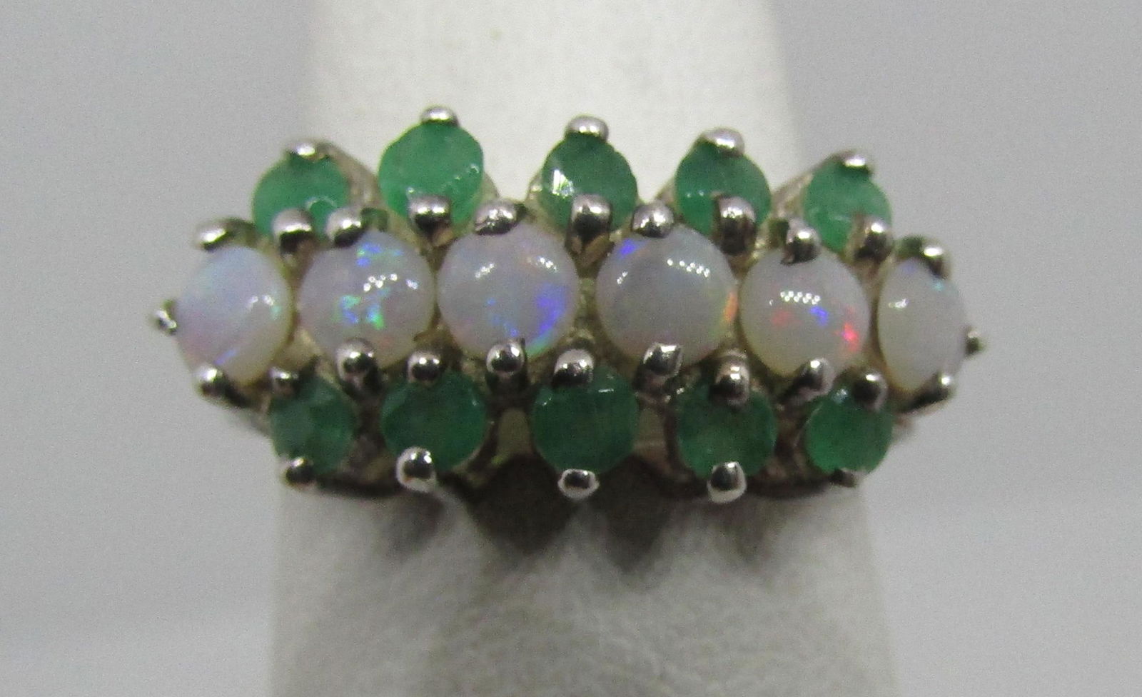 EMERALD OPAL BAND RING STERLING SILVER: VINTAGE ESTATE HALLMARKED "D" IN A CROWN STERLING SILVER WITH 10 GENUINE EMERALDS AND 6 OPALS. TOP 21MM BY 10MM. SIZE 7. WEIGHS 3.3 GRAMS. GREAT USED CONDITION.10 GENUINE USA SHIPPING $5.