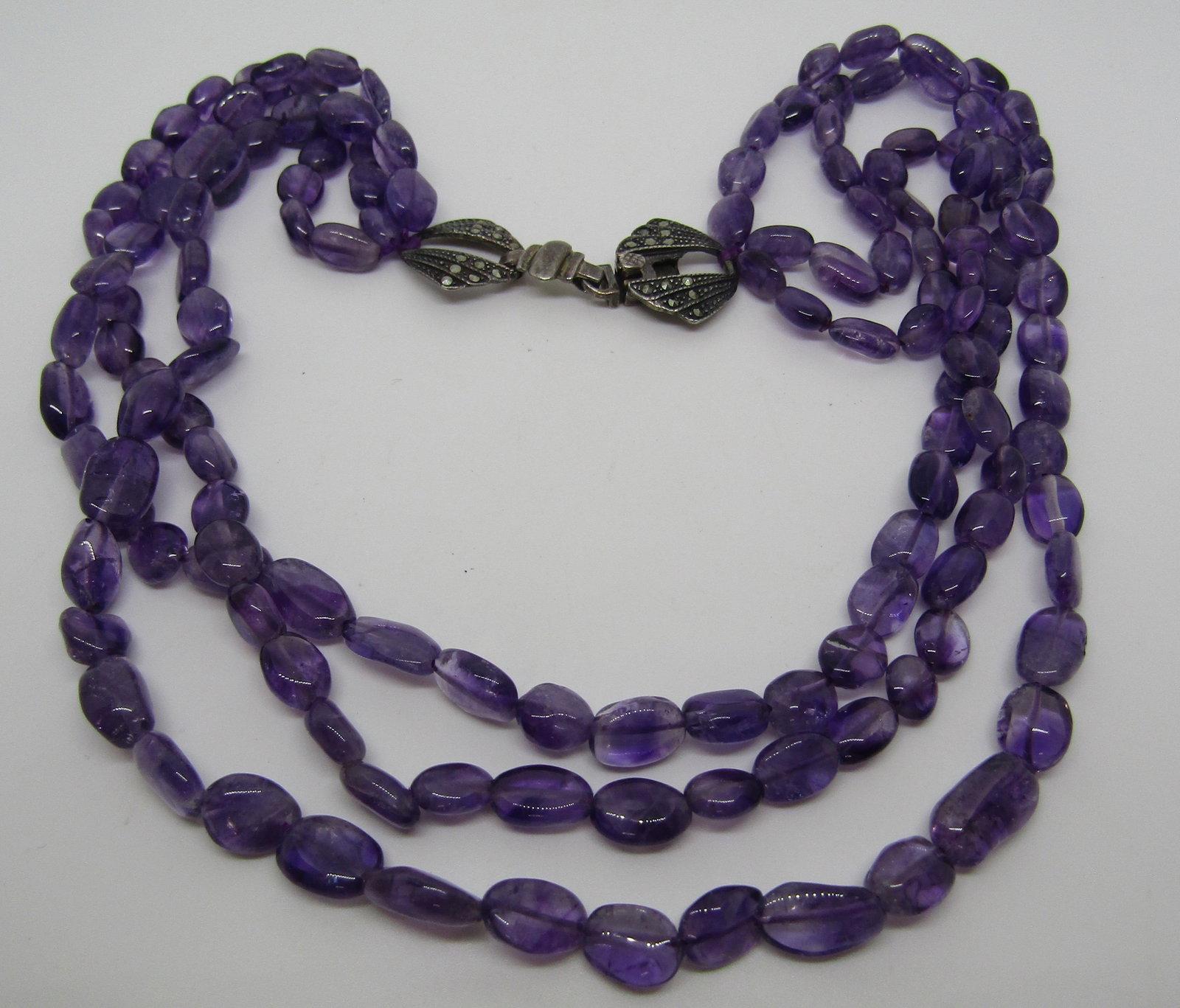 3 STR AMETHYST NECKLACE STERLING SILVER MARCASITE: VINTAGE ESTATE THREE STRAND 18 INCH AMETHYST NECKLACE. 10MM TO 13MM AMETHYST STONES. WEIGHT: 59.4 GRAMS. HALLMARKED WITH "Y" 925. USA SHIPPING $5.