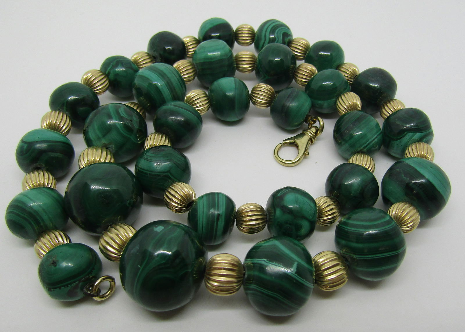 17MM MALACHITE BEAD NECKLACE 14K YELLOW GOLD.: VINTAGE ESTATE 22.5 INCH LONG STRAND WITH GENUINE MALACHITE STONES 17MM TO 12MM. WITH 14K YELLOW GOLD 7MM FLUTED BEADS. WEIGHT: 152.2 GRAMS. USA SHIPPING $8.