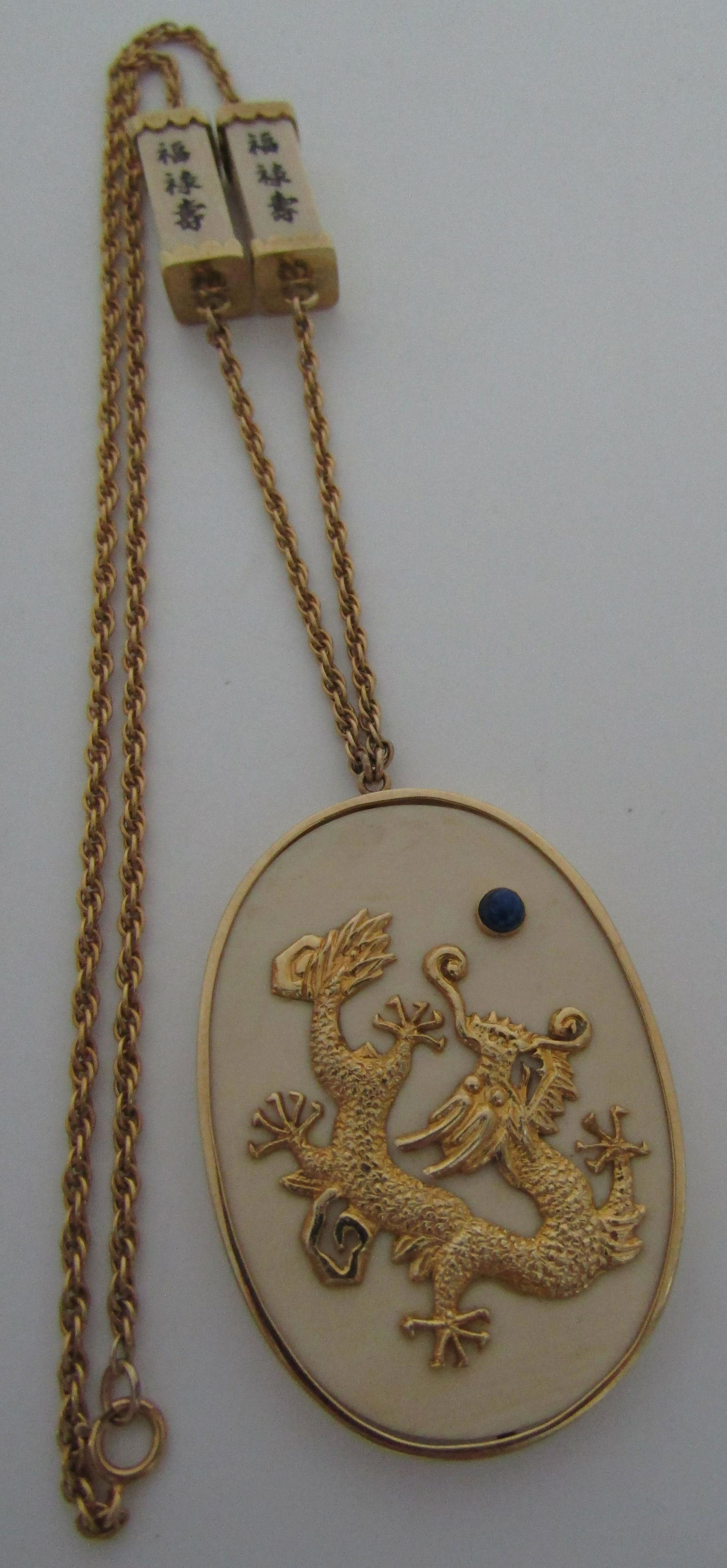 SOLID 14K GOLD DRAGON PENDANT NECKLACE LAPIS: LARGE VINTAGE ETATE CHINESE DRAGON WITH WRITING LOOKS LIKE HAPPINESS AND COURAGE. CATCH MARKED 14K. ALL PARTS TESTED 14K YELLOW GOLD. WEIGHS 26.3. LINK CHAIN 20 INCHES LONG. PENDANT 2 1/8" LONG BY 1 1