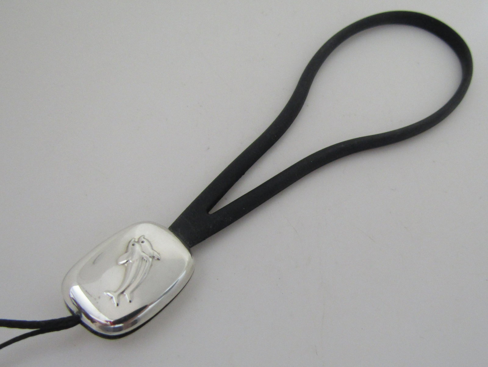 GEORG JENSEN DK STERLING SILVER CHARM BRACELET: MARKED "GEORG JENSEN 925S DENMARK". EXCELLENT CONDITION, NEVER USED BRACELET. RUBBER STRAP WILL FIT ANY WRIST, MAN OR FEMALE. STERLING SILVER DOLPHIN PENDANT. USA SHIPPING $5