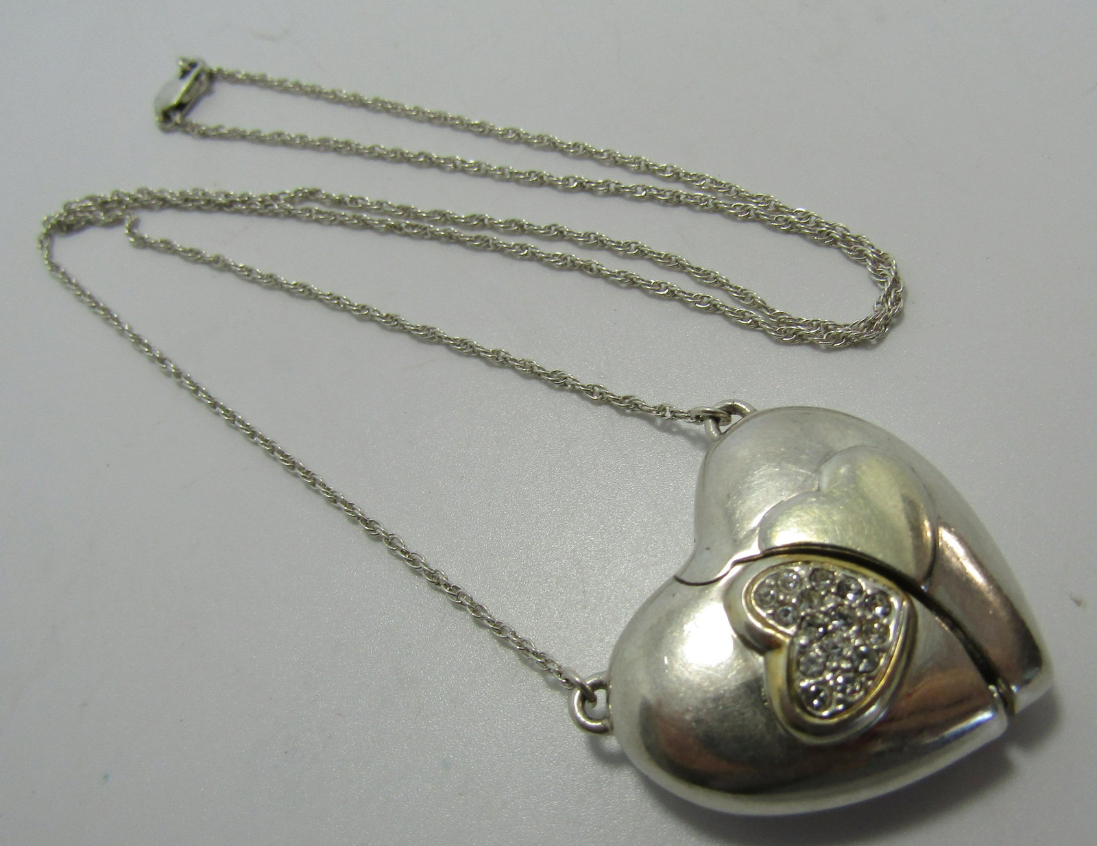 LENOX HEART LOCKET GOLD N STERLING SILVER NECKLACE: GENUINE 21 INCH LONG NECKLACE WITH 26MM BY 28MM HEART WITH CZ'S. THAT OPENS TO REVEAL ANOTHER LOVE HEART GOLD ON STERLING. WEIGHS 18 GRAMS. USED CONDITION. USA SHIPPING $5.