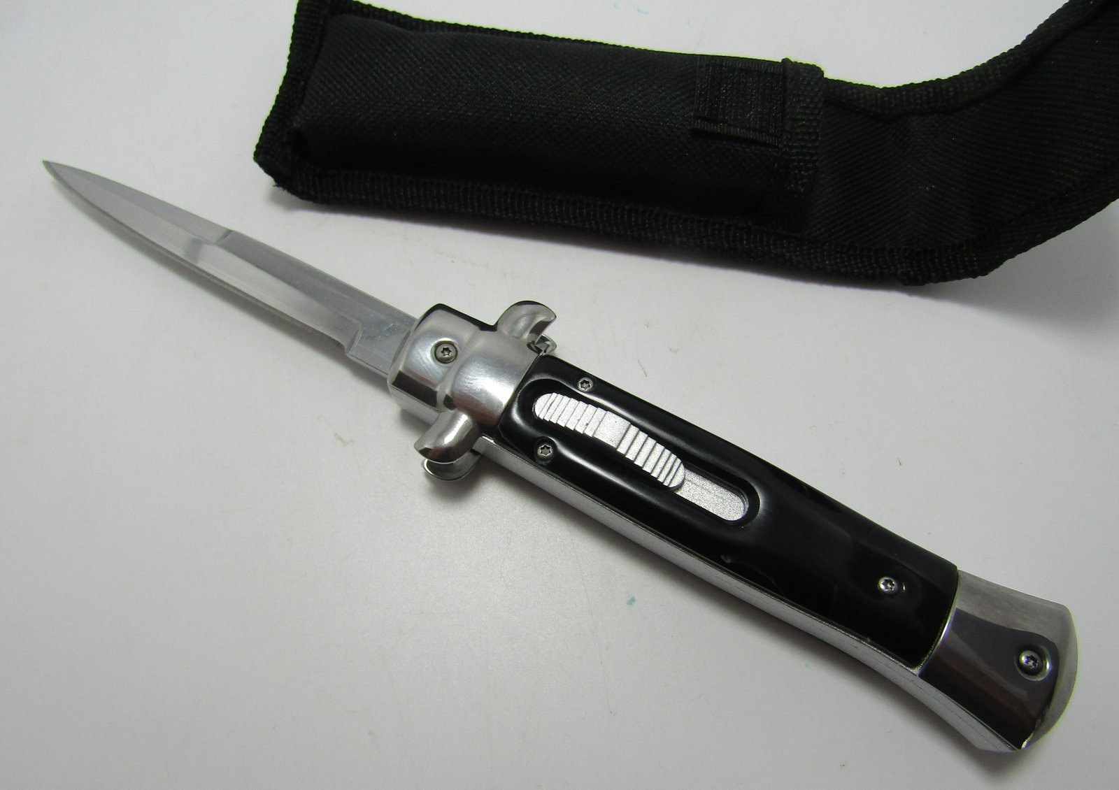 SLIDE LOCK SWITCHBLADE KNIFE OTF: OUT THE FRONT SLIDE LOCK SWITCHBLADE. 9 INCH LONG WITH 4 INCH BLADE BLACK PEARIZED GRIP. USA SHIPPING $5