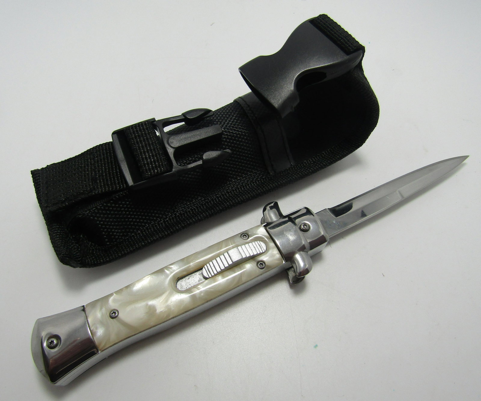 SLIDE LOCK SWITCH BLADE KNIFE OTF: OUT THE FRONT SLIDE LOCK SWITCHBLADE. 9 INCH LONG WITH 4 INCH BLADE WHITE PEARIZED GRIP. USA SHIPPING $5