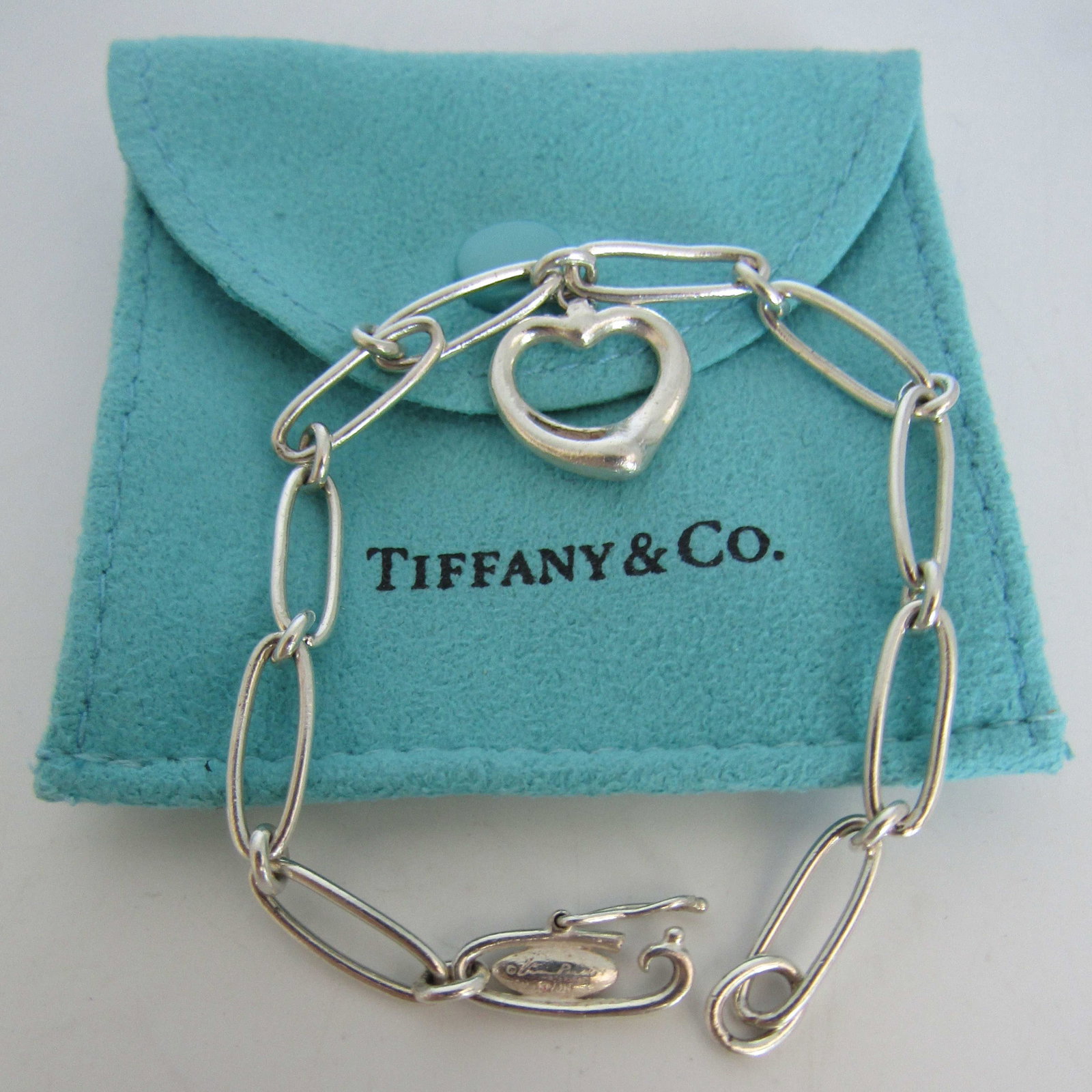 TIFFANY & CO CHARM BRACELET STERLING SILVER LINK: GENUINE SIGNED "TIFFANY & CO. 925 ELSA PERETTI" MEASURES 7 INCHES LONG. HEART CHARM 15MM BY 14MM. WEIGHS 7.5 GRAMS. WITH TIFFANY POUCH. USED CONDITION. USA SHIPPING $5