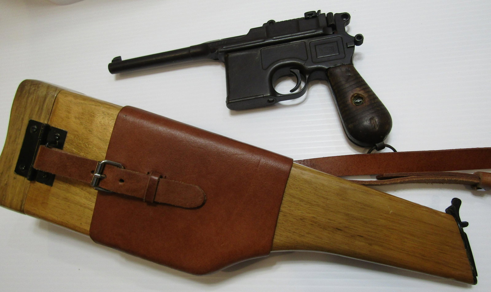 GERMAN MAUSER C96 BROOMHANDLE PISTOL & STOCK WW1: GERMAN C96 MAUSER 7.63 MM MATCHING SERIAL NUMBER 818221 NICE OPERATING CONDITION HAS SOME PITTING WORN WOOD GRIPS. 5 1/4 INCH BARREL HAS NEWER WOOD HOLSTER STOCK. FFL REQUIRED & SHIPPING $60