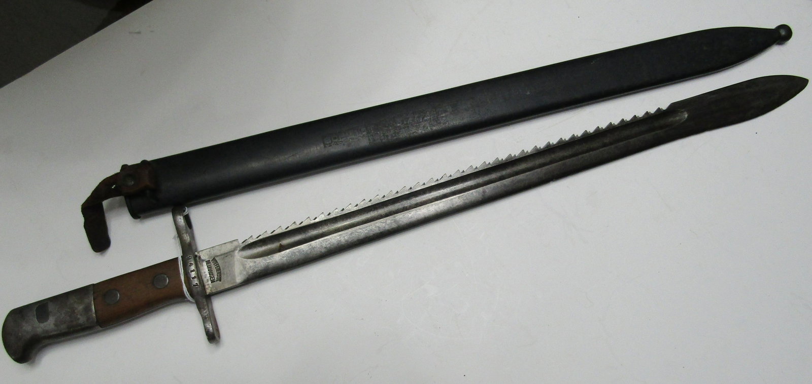 GERMAN SAW BACK BAYONET NEUHAUSEN: WAFFENFABRIK NEUHAUSEN SIGNED SAWBACK BAYONET WITH SCABARD 23 1/2 INCH LONG WITH 18 1/2 INCH BLADE. SERIAL NO 94117. USA SHIPPING $20