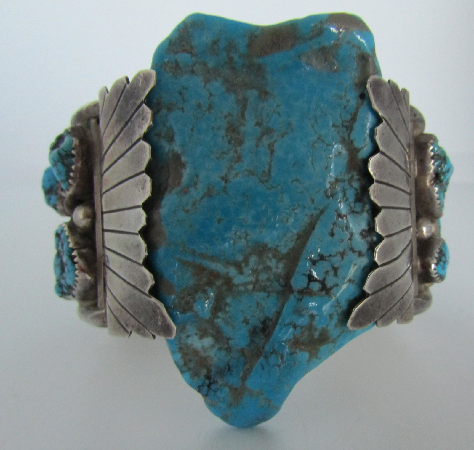 J?B TURQUOISE CUFF BRACELET STERLING SILVER: 14 FABULOUS GEM TURQUOISE, POSSIBLE BISBEE, BEZEL SET ON SIDES. HUGE PIECE OF KINGMAN IN CENTER. OLD PAWN HALLMARKED "J?B" TESTED STERLING SILVER VINTAGE ESTATE NATIVE AMERICAN SOUTHWEST NAVAJO INDIAN