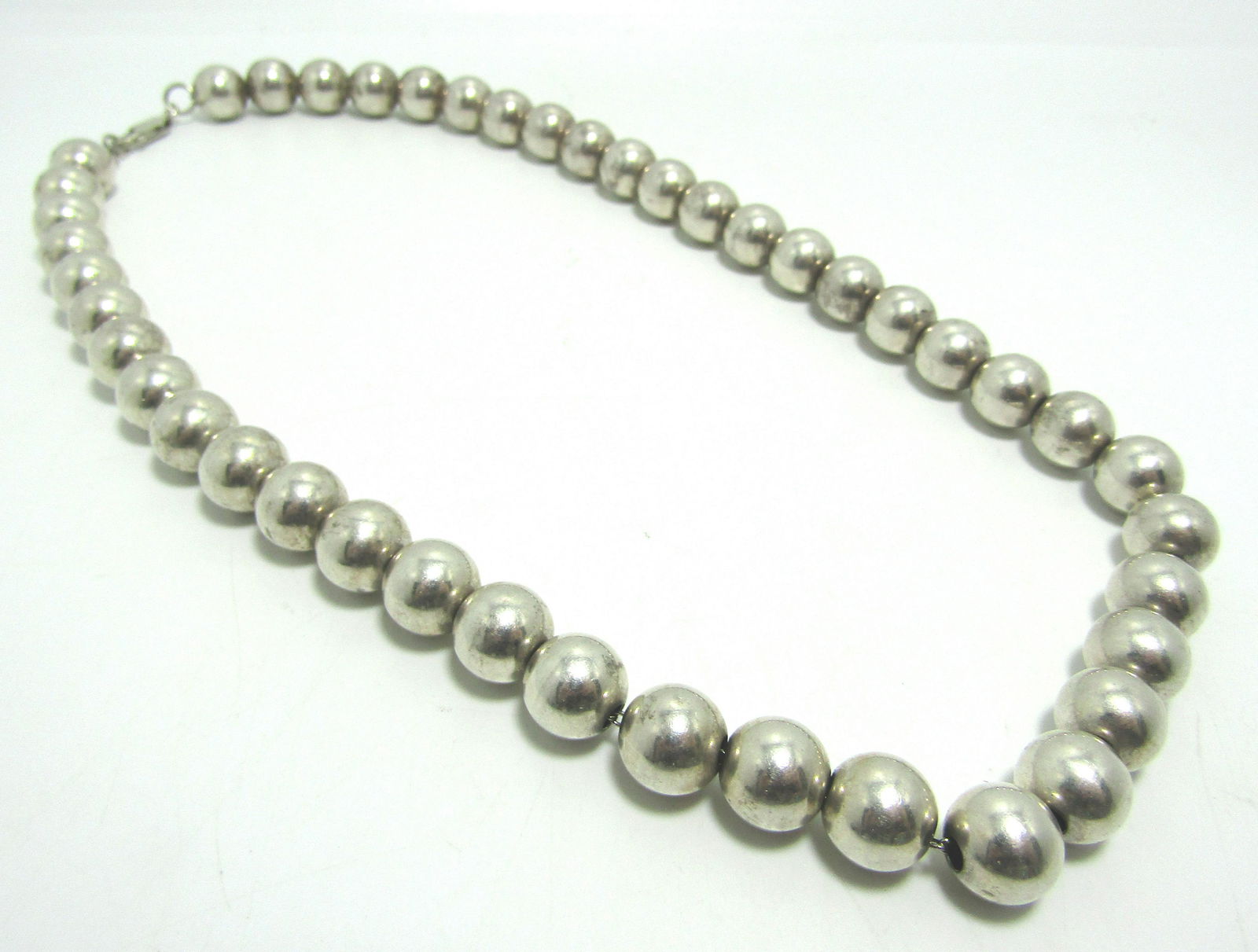 10MM STERLING SILVER BEAD NECKLACE 39 GRAMS: BEADS ARE 10MM DIAMETER, NECKLACE IS 18" LONG. VINTAGE CONDITION. DOUBLE EYE LOBSTER CLAW CLASP. TESTED STERLING SILVER. WEIGHS 39 GRAMS. USA SHIPPING $5.